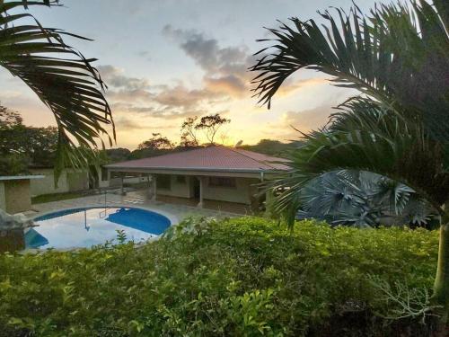 a house with a swimming pool in front of it at Quinta Alfa in Grecia
