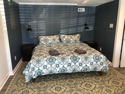 a bedroom with a bed with a blanket and pillows at Heart Of Hickory Home #2 Open Layout Studio Apt in Hickory