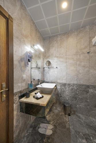 a bathroom with a sink and a toilet in it at Perapolis Hotel in Istanbul