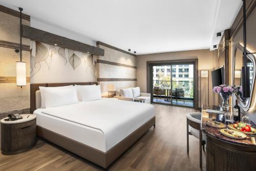 a hotel room with a bed and a desk at Kempinski Hotel The Dome Belek in Belek