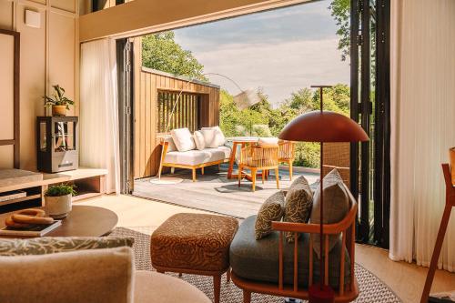 a living room with a view of a patio at South Lodge in Lower Beeding