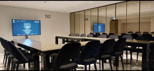 a conference room with a long table and chairs at Grand Hotel Kalamata in Kalamata