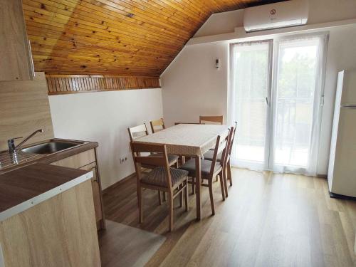 a kitchen and dining room with a table and chairs at Holiday home in Siofok - Balaton 20050 in Siófok