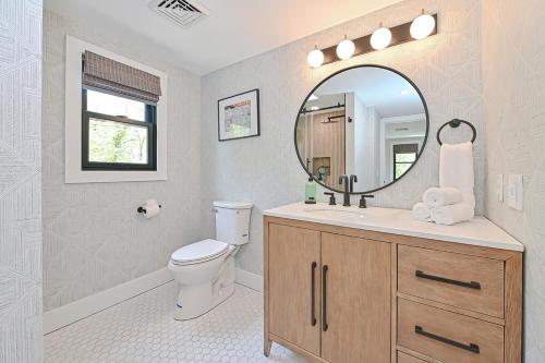 a bathroom with a toilet and a mirror at 5mins2beach, Hottub, Gameroom, Petsok in Dennis