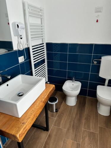 a bathroom with a sink and a toilet at La Briga in Piaggia