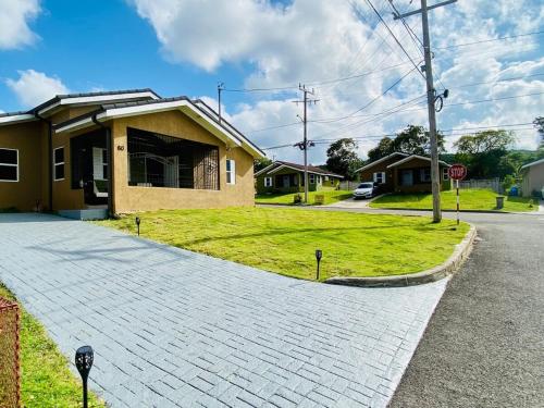 a brick driveway leading to a house with a stop sign at Jhadano 3br Pool & Gym Shuttle Gated in Florence Hall