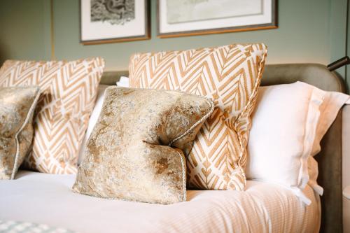 a couch with two pillows on top of it at South Lodge in Lower Beeding