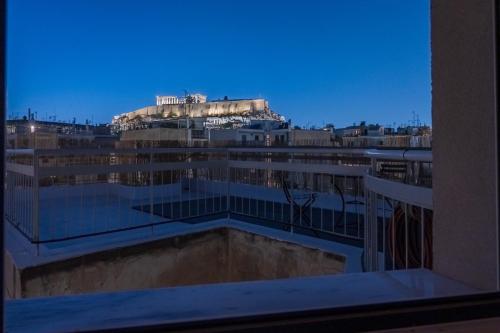 a view of a city from a window of a building at Unique 2BR Penthouse with Stunning Acropolis View in Athens