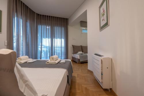 a hotel room with two beds and a window at Unique 2BR Penthouse with Stunning Acropolis View in Athens