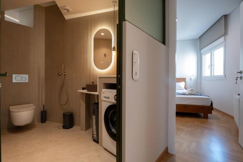 a bathroom with a washer and dryer in a room at Unique 2BR Penthouse with Stunning Acropolis View in Athens