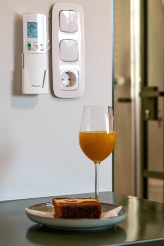 a glass of orange juice and a plate of bread at Unique 2BR Penthouse with Stunning Acropolis View in Athens
