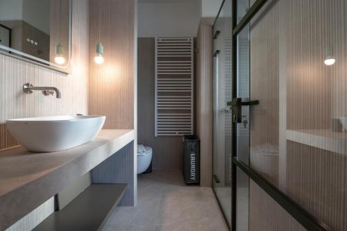 a bathroom with a white sink and a toilet at Unique 2BR Penthouse with Stunning Acropolis View in Athens