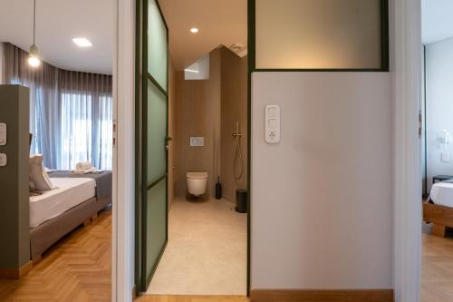 a room with a door leading to a bedroom at Unique 2BR Penthouse with Stunning Acropolis View in Athens