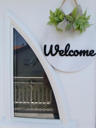 a sign for welcome on a wall with a window at DreamHouse in Jajce