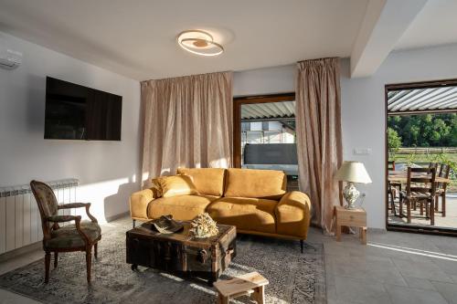 a living room with a couch and a table at Mountain Houses Volta in Lič