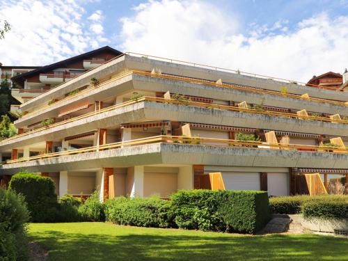 a large building with a lawn in front of it at Studio Terrasse Des Alpes 615 by Interhome in Vermala