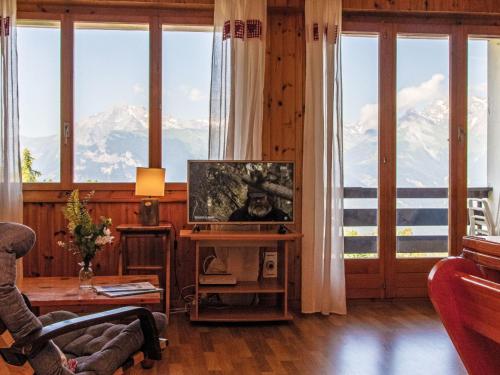 a living room with a view of a mountain at Apartment Chaedoz 43 by Interhome in Nendaz