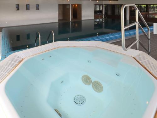 a jacuzzi tub with two coins in it at Apartment Terrasse Des Alpes 708 by Interhome in Vermala