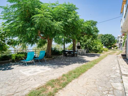 a patio with chairs and a table under a tree at Apartment Daria 2 by Interhome in Anić