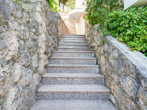 a stone wall with stairs leading up to a door at Apartment Daria 2 by Interhome in Anić