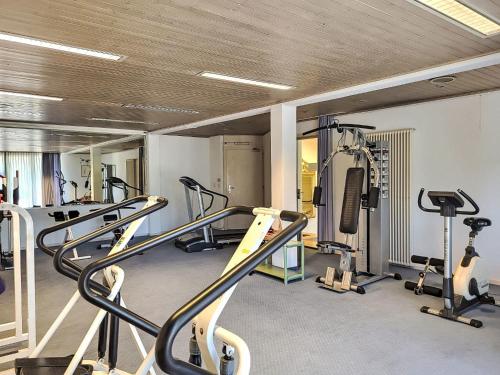 a gym with several treadmills and cardio machines at Apartment App- 511 by Interhome in Bissone