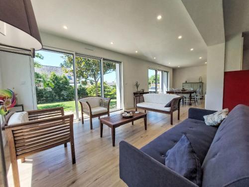 a living room with a blue couch and chairs at Holiday Home Bon Port by Interhome in Saint-Philibert