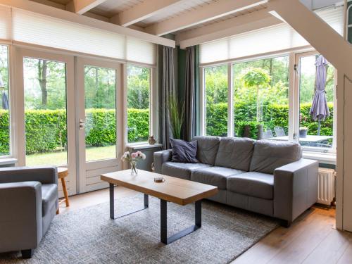 a living room with a couch and a coffee table at Holiday Home 4-persoons by Interhome in Dalfsen