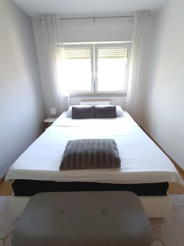 a large bed in a room with a window at DreamHouse in Jajce