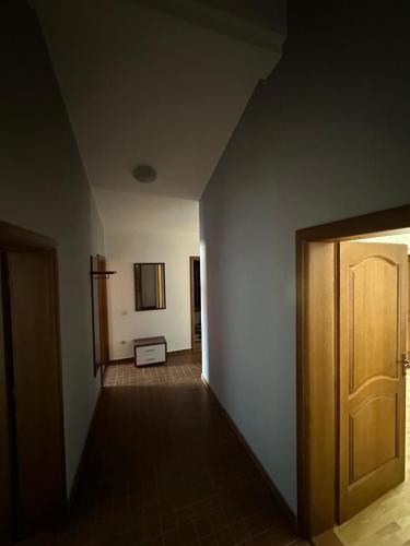 an empty hallway with a door in a room at Stellax Apartment in Donji Štoj