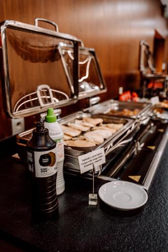 a counter top with a bunch of food on at Hotel Pajero in Horbów