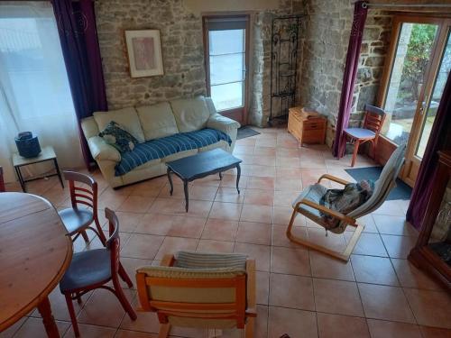 un salon avec un canapé, une table et des chaises dans l'établissement Beau gîte 3 épis gîte de france, excellent emplacement de très belles plages , en bretagne sud, à Plouhinec