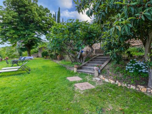 a garden with stairs and a bench and trees at Holiday Home La Torre-4 by Interhome in Stigliano