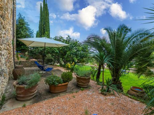a patio with potted plants and an umbrella at Apartment Torre 4 by Interhome in Stigliano