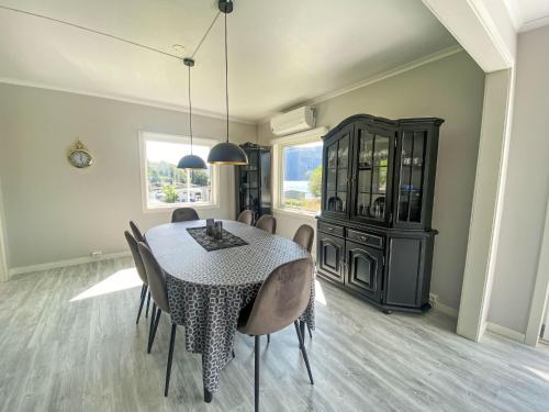 a dining room with a table and chairs at Holiday Home Sjøtun by Interhome in Hyllestad