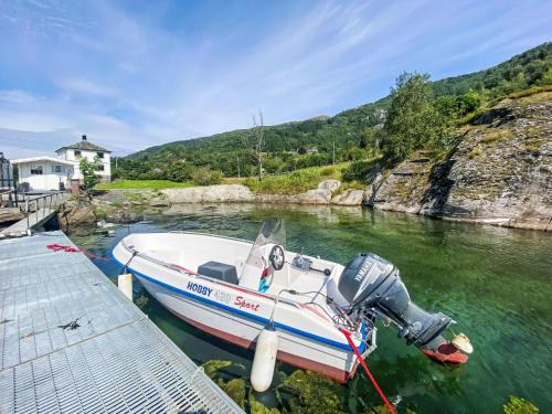 a boat is docked at a dock in the water at Holiday Home Sjøtun by Interhome in Hyllestad