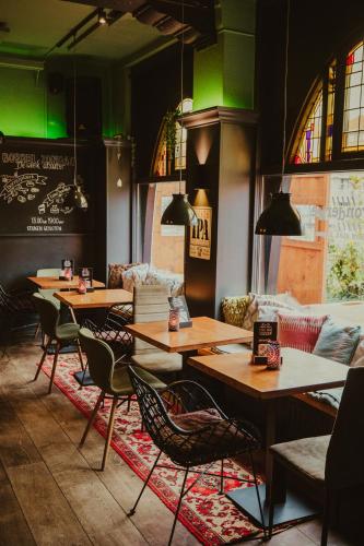 a restaurant with tables and chairs and green lighting at cafe 't Vonderke in Eindhoven