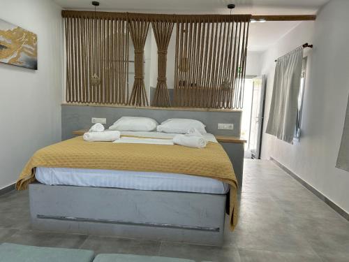 a bedroom with a bed with two towels on it at George Studios 1 in Kanala