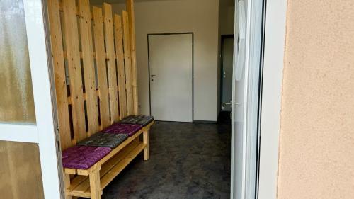 a hallway with a bench in a room with a door at Wohlfühlen im Zuhause auf Zeit in Wildon