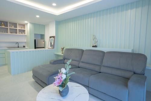a living room with a couch and a table at Three One East in Nong Prue