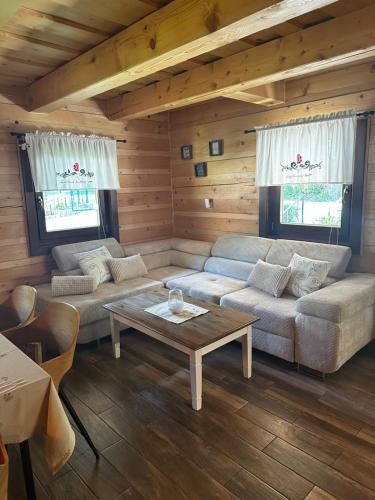 a living room with couches and a coffee table at Chata Nezábudka in Oščadnica
