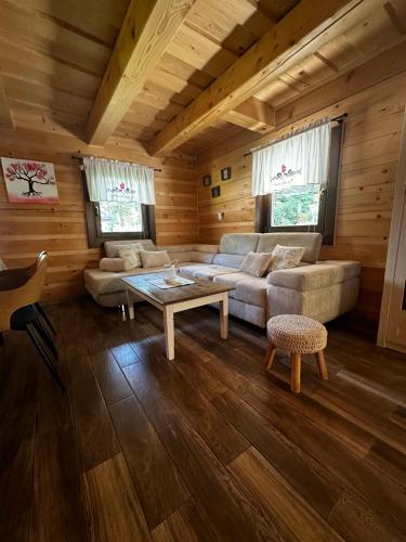 a living room with a couch and a table at Chata Nezábudka in Oščadnica