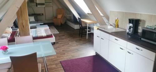 a room with a kitchen and a living room at Ferienwohnung Herbstsonne 2 in Burg