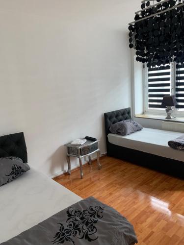 a bedroom with a bed and a couch and a window at Unterkunft Mara in Oberhausen