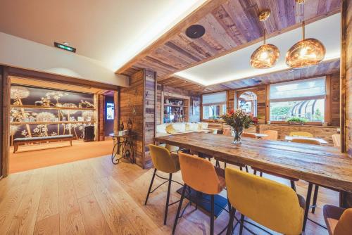 a dining room with a large wooden table and chairs at La Clef des Champs in Morzine