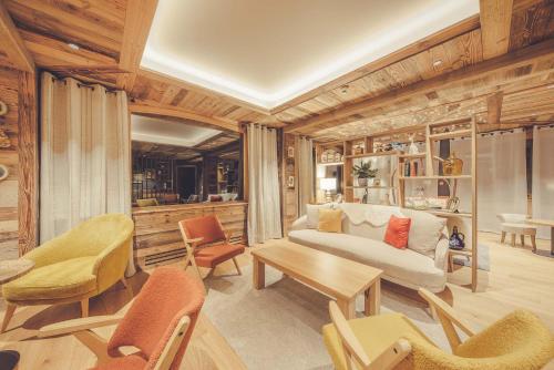 a living room with a couch and a table and chairs at La Clef des Champs in Morzine