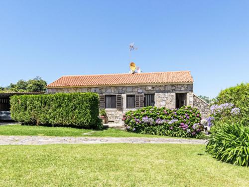 a man sitting on top of a house at Holiday Home Do Condado by Interhome in Caminha
