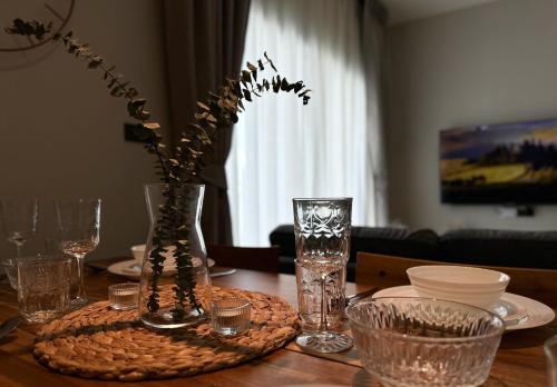 a dining room table with a vase with flowers in it at The Title Halo 1 Apartment 10 min to Nai Yang Beach in Nai Yang Beach