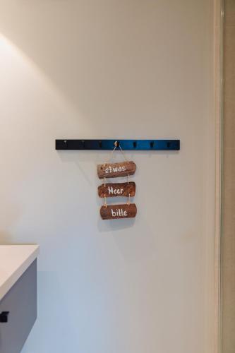 a sign hanging on a wall in a room at Seetiid in Westerland (Sylt)