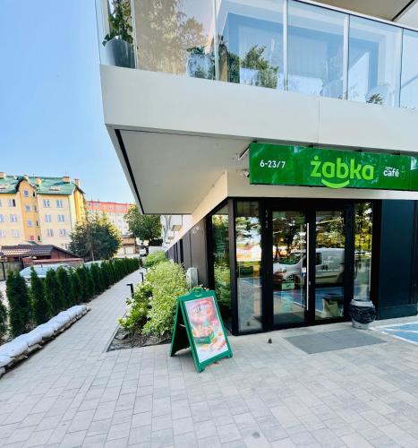 a building with a sign in front of it at H ApartStudio Targowa 4 in Ełk