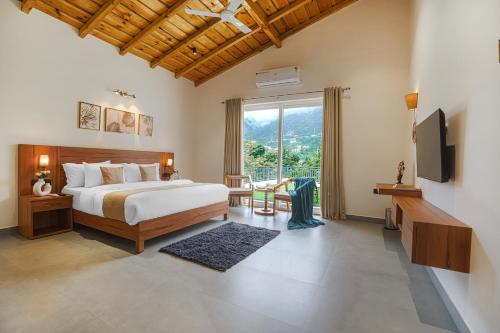 a bedroom with a bed and a large window at SaffronStays Bourbon in Bhīm Tāl